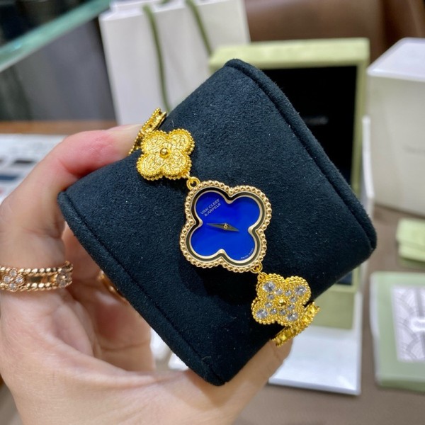Van Cleef & Arpels watch with blue mother-of-pearl and diamond-set clover motif, featuring a blue dial.